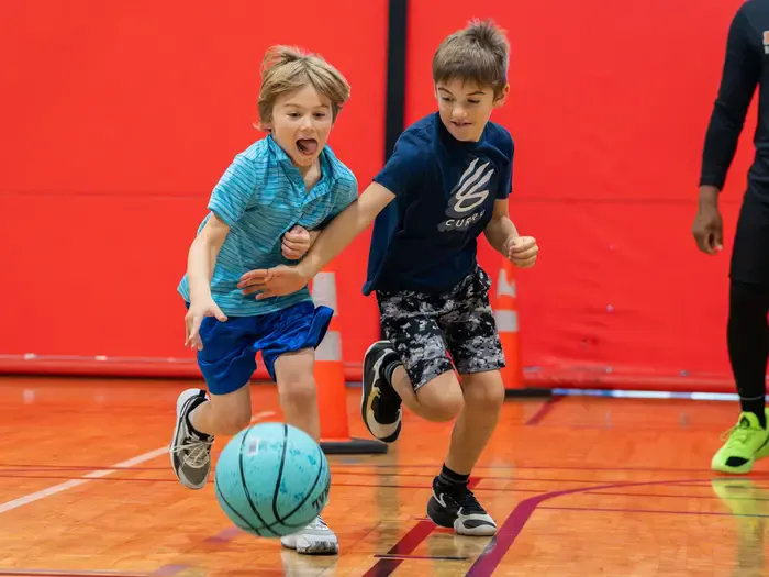 Two young players competing for the ball in a game-like drill