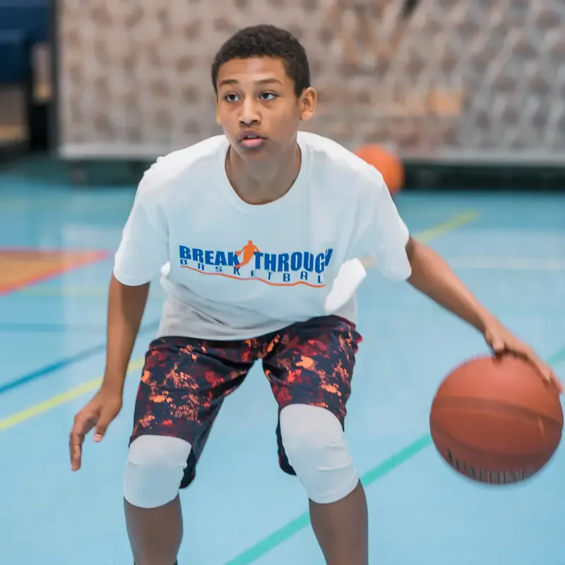 Player working on ball handling in a basketball skills training session